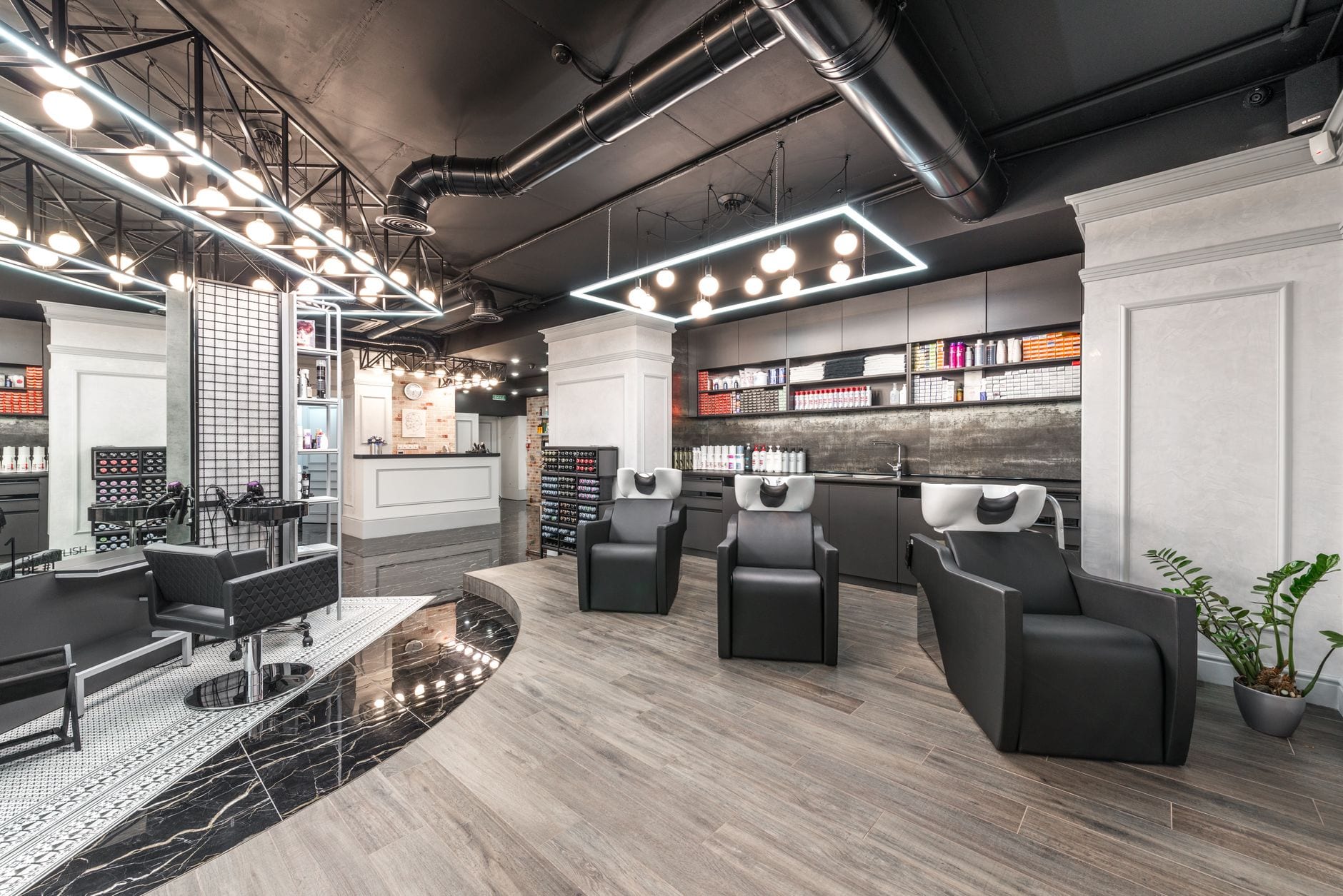 Modern salon interior with warm lighting and upscale styling stations